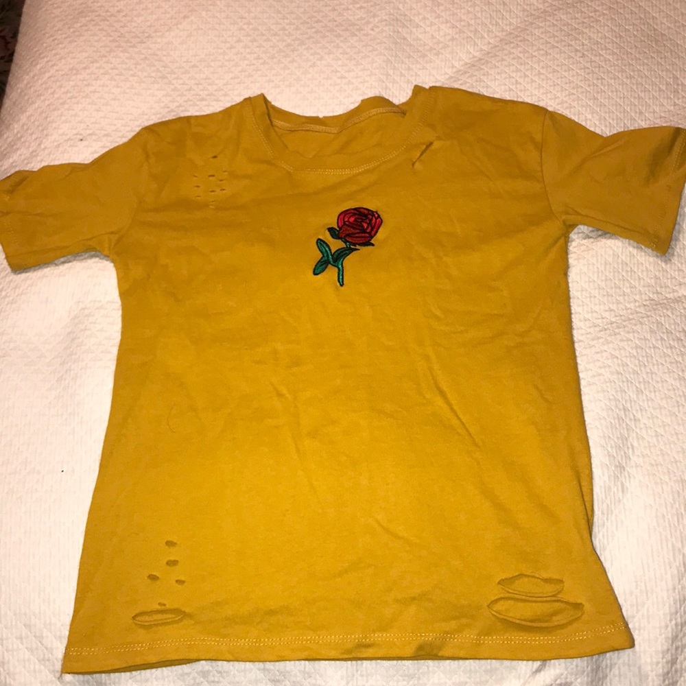 Distressed shirt with rose embroidery.